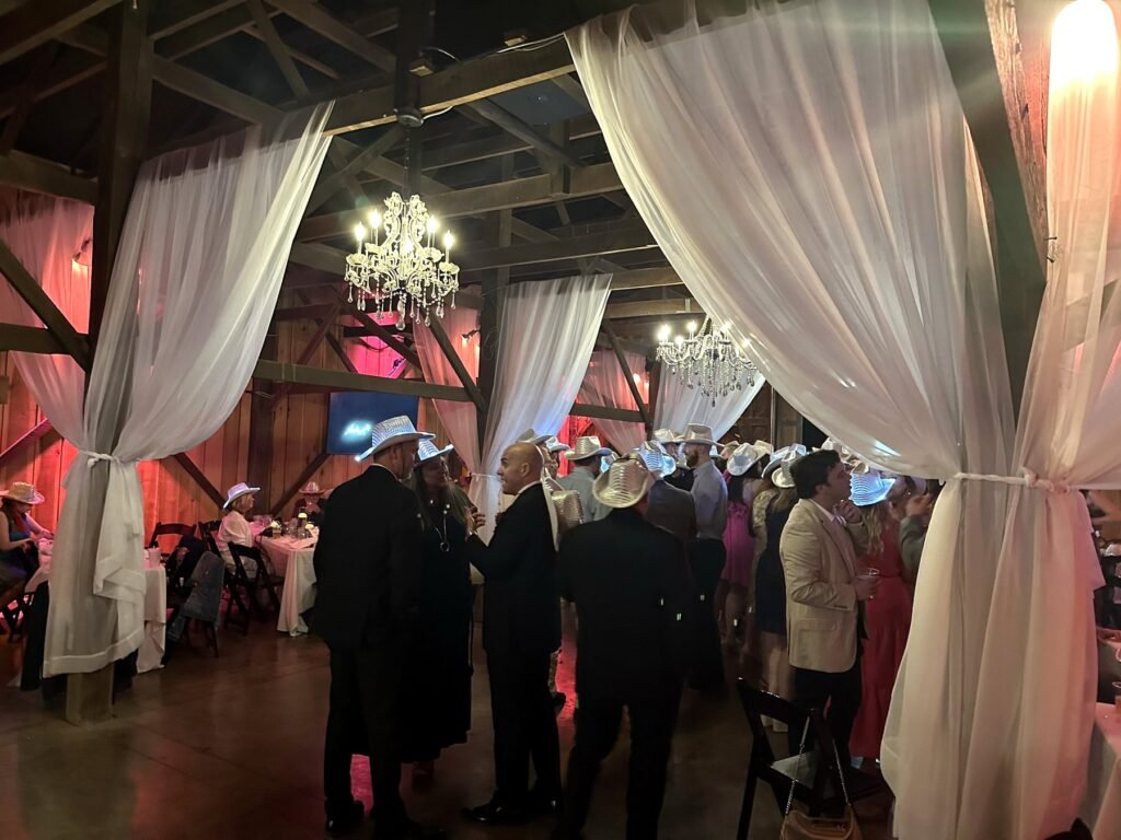 Guests in sparkly white cowboy hats on the dance floor at a Farmer & Frenchman wedding reception near Henderson, KY