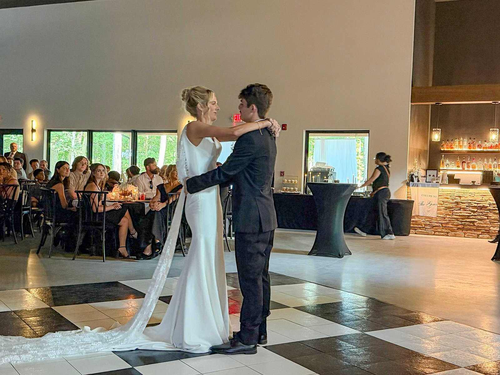 Bride and groom sharing a slow dance on the checkered floor at their Highbanks reception.